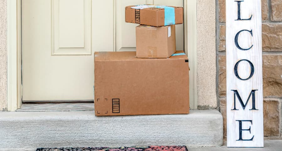 Deliveries on the front porch of a house with a welcome sign in St. Paul